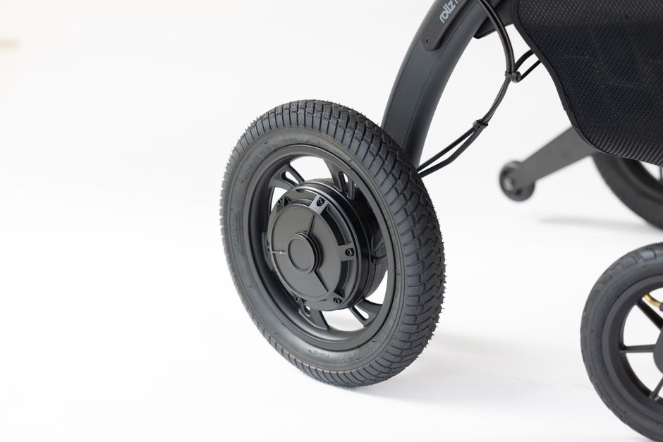 Detailed close-up of a wheel on a modern mobility device against a white background.